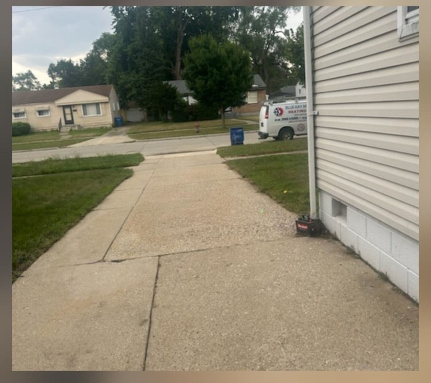 Concrete driveway and curb bright and clean after surface cleaning